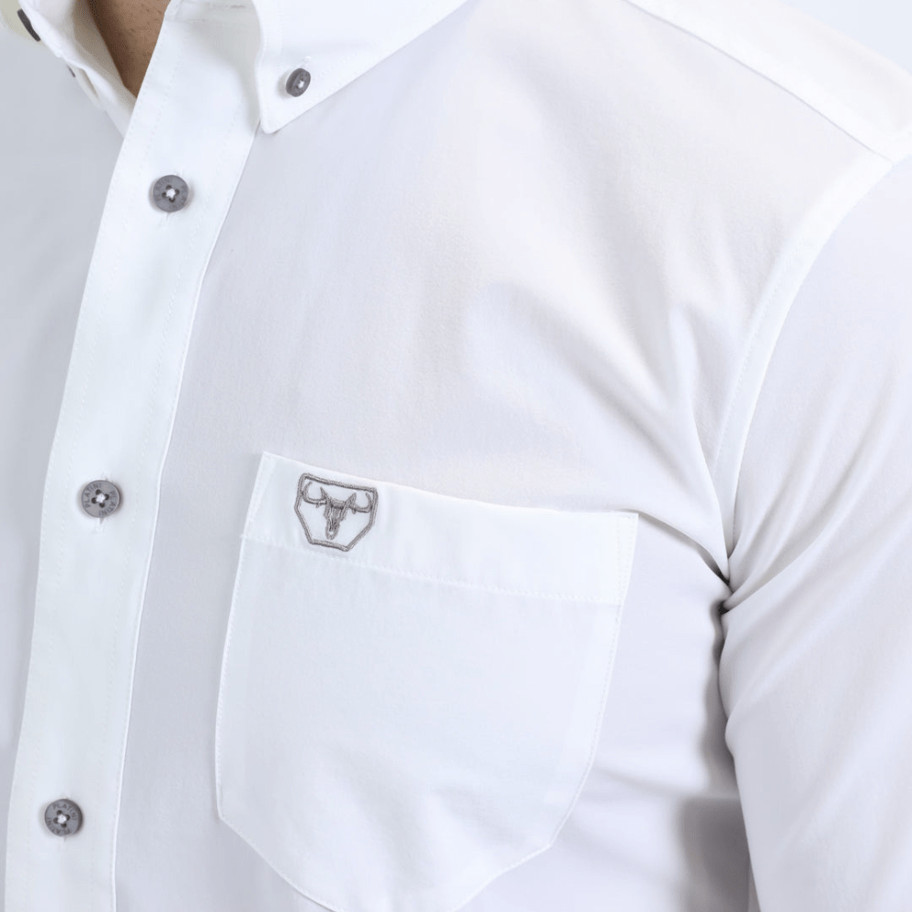 Acercamiento al bolsillo con botón y logotipo bordado en el pecho.