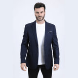 Modelo con saco azul marino y camiseta blanca, estilo moderno.
