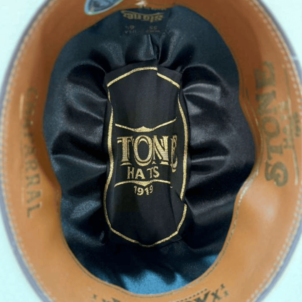 Interior negro con sello Stone Hats dorado.