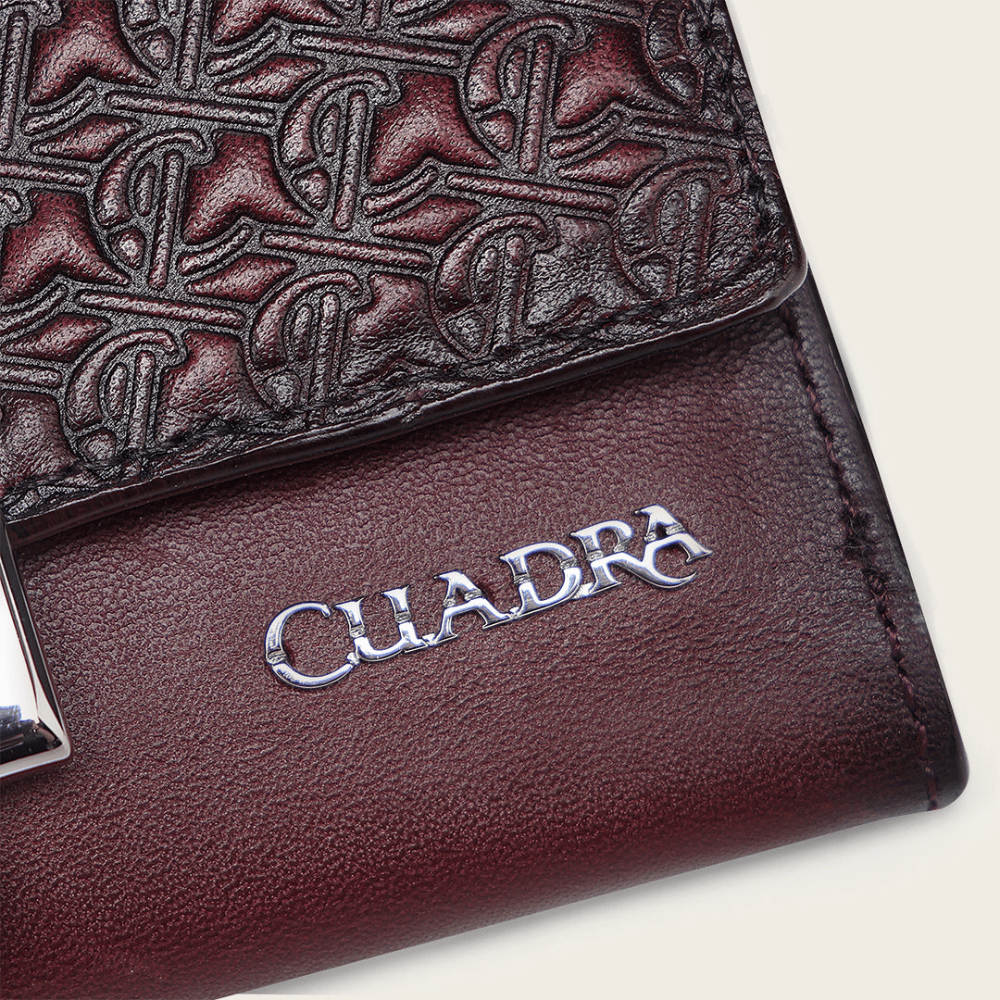 Acercamiento al detalle de la piel y el grabado con logotipo Cuadra.
