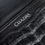 Detalle en primer plano del logotipo metálico “Cuadra”.