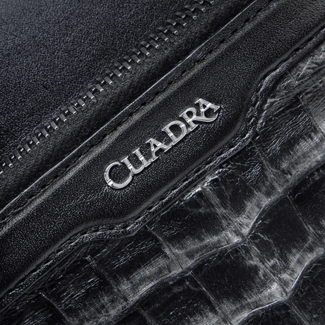 Detalle en primer plano del logotipo metálico “Cuadra”.